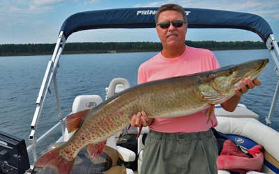 image of Phil Jensen holding big Musky